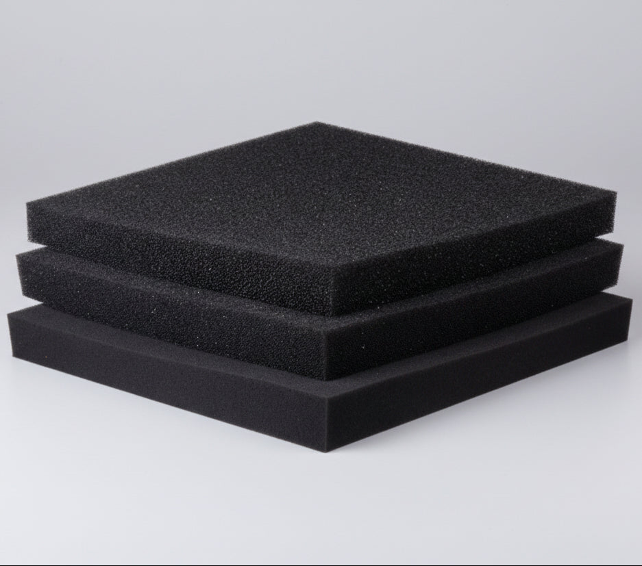 Three black foam pads stacked on a white background