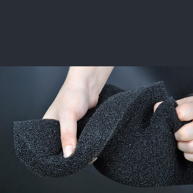 Black foam finger held by a person against a dark background