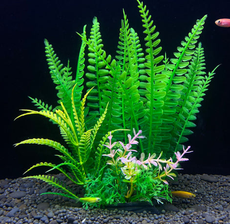 Artificial green fern plant with small flowers on a dark background
