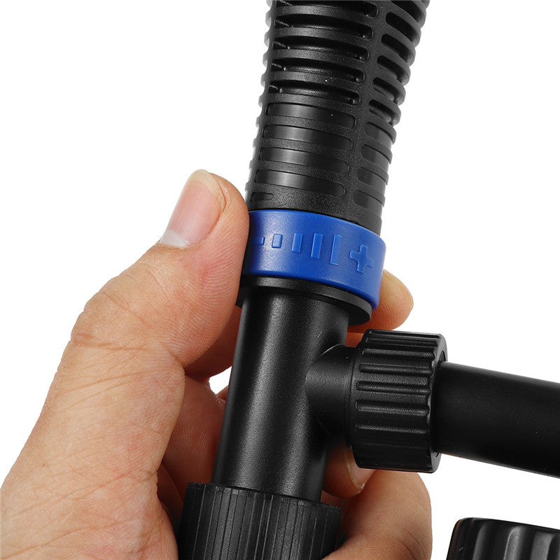 Hand holding a black and blue hose connector against a white background