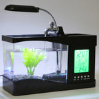 Black desk aquarium with digital clock display, green plants, and water faucet.