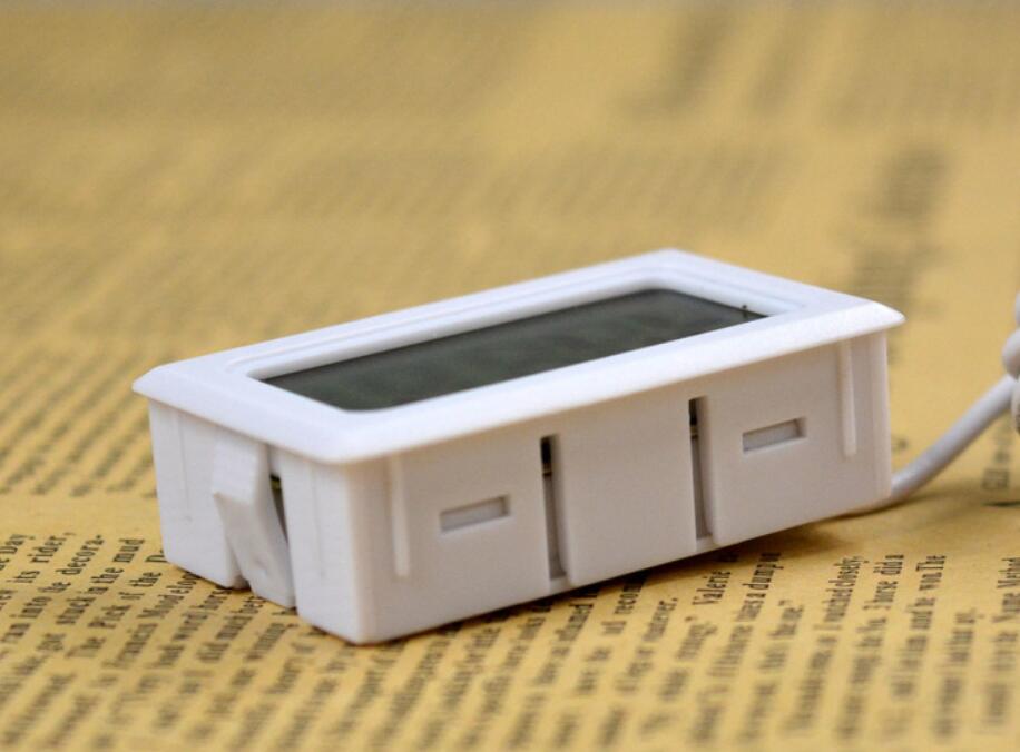 Small electronic device with a digital display on a textured surface