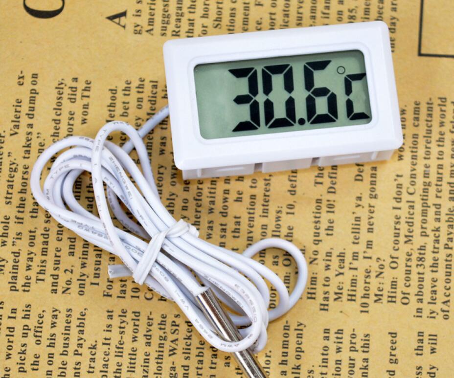 Digital thermometer with a cable on a textured paper background