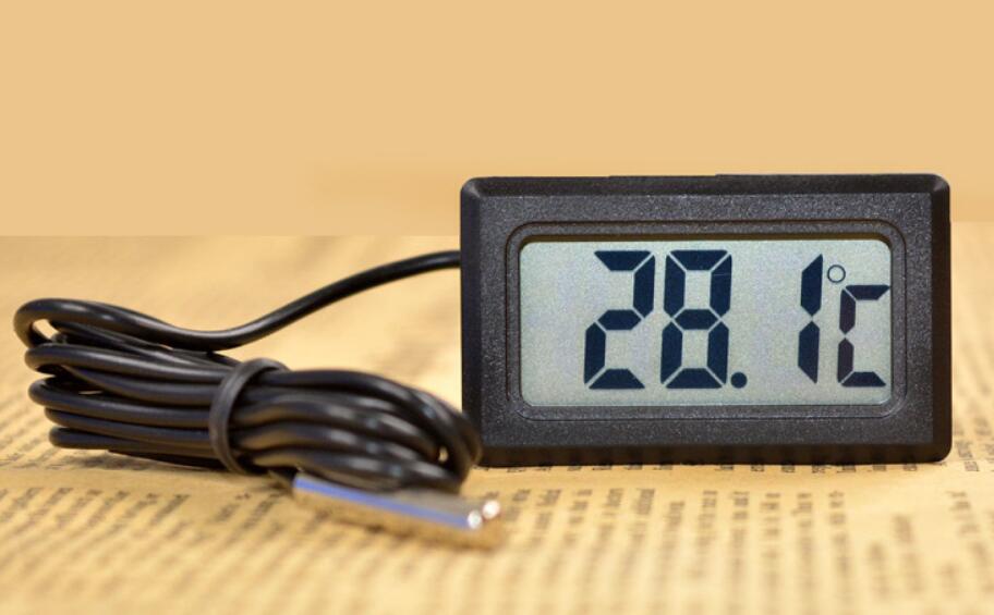 Digital thermometer with cable on a textured surface